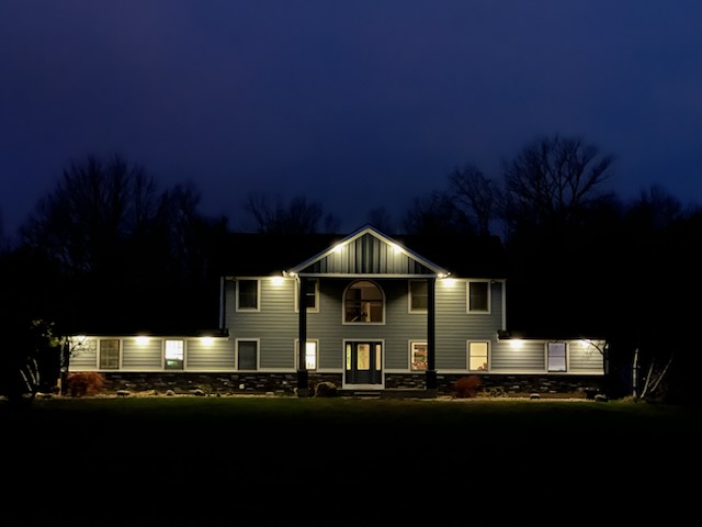 Exterior shot of house at night with security lighting