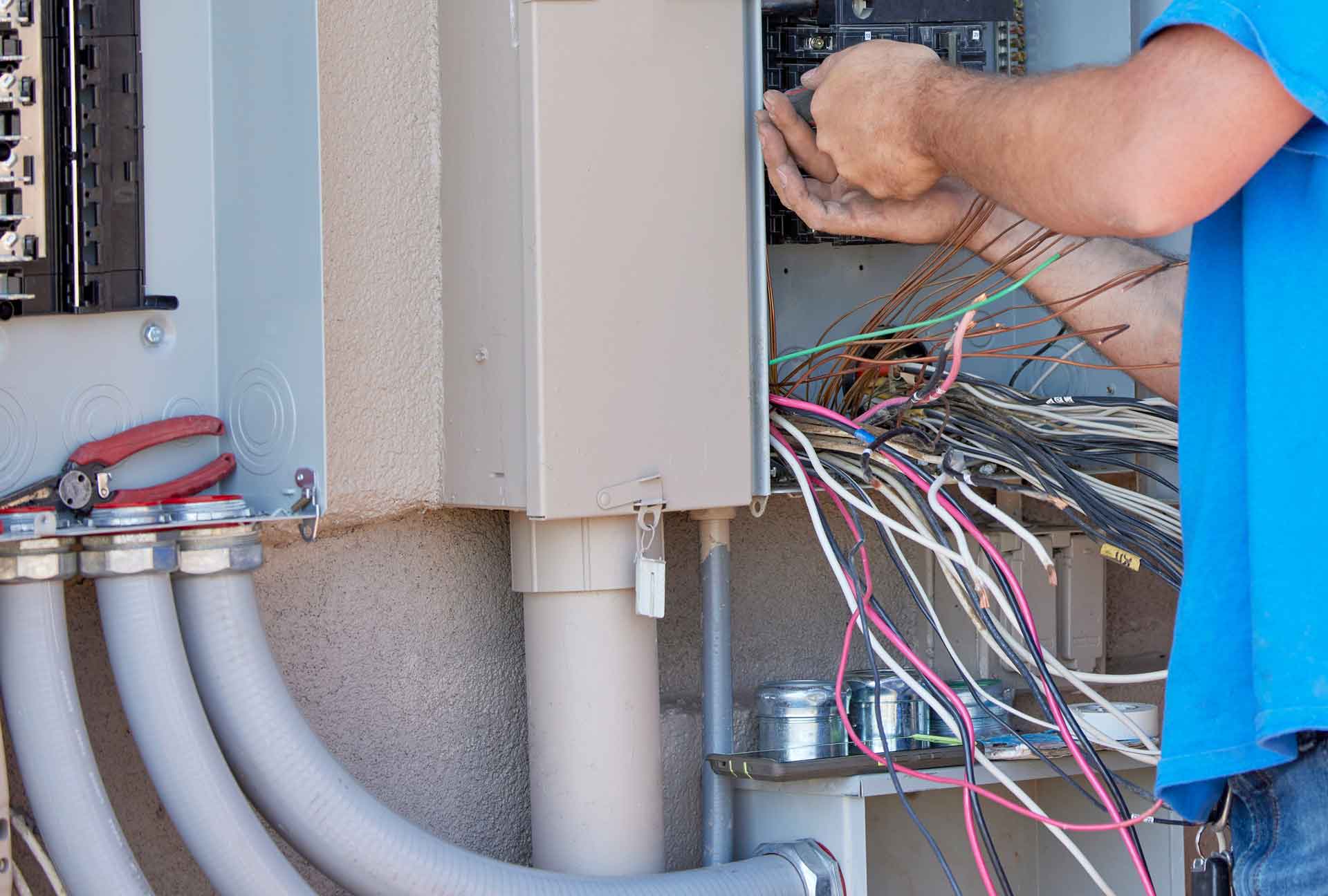 Electrician installing a transfer panel for a residential generator